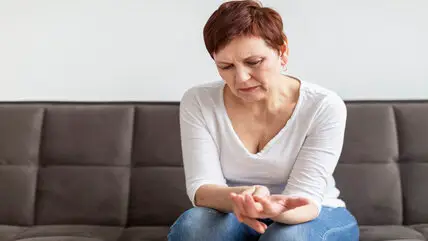 Senior woman with joint pain showing effects of chronic inflammation and aging